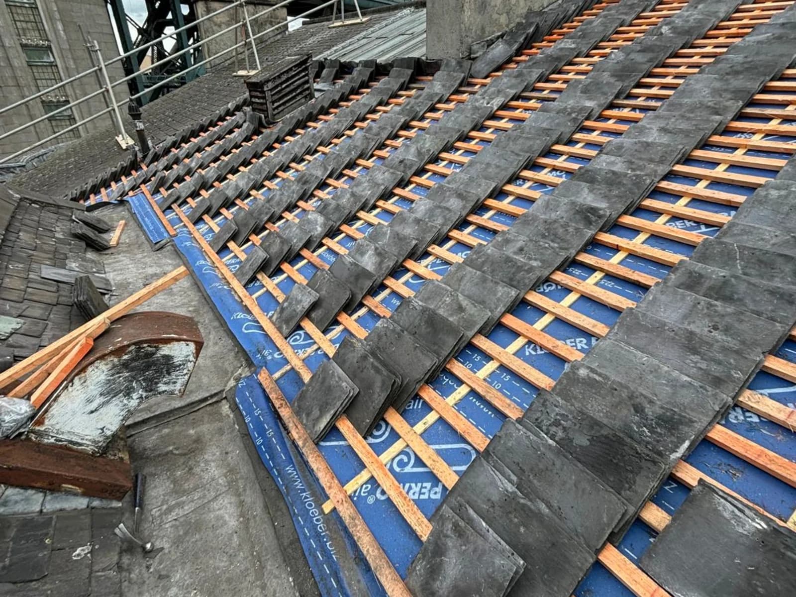 Completed natural slate roof in Newcastle with the Tyne Bridge in the background — local-landmark heritage capability