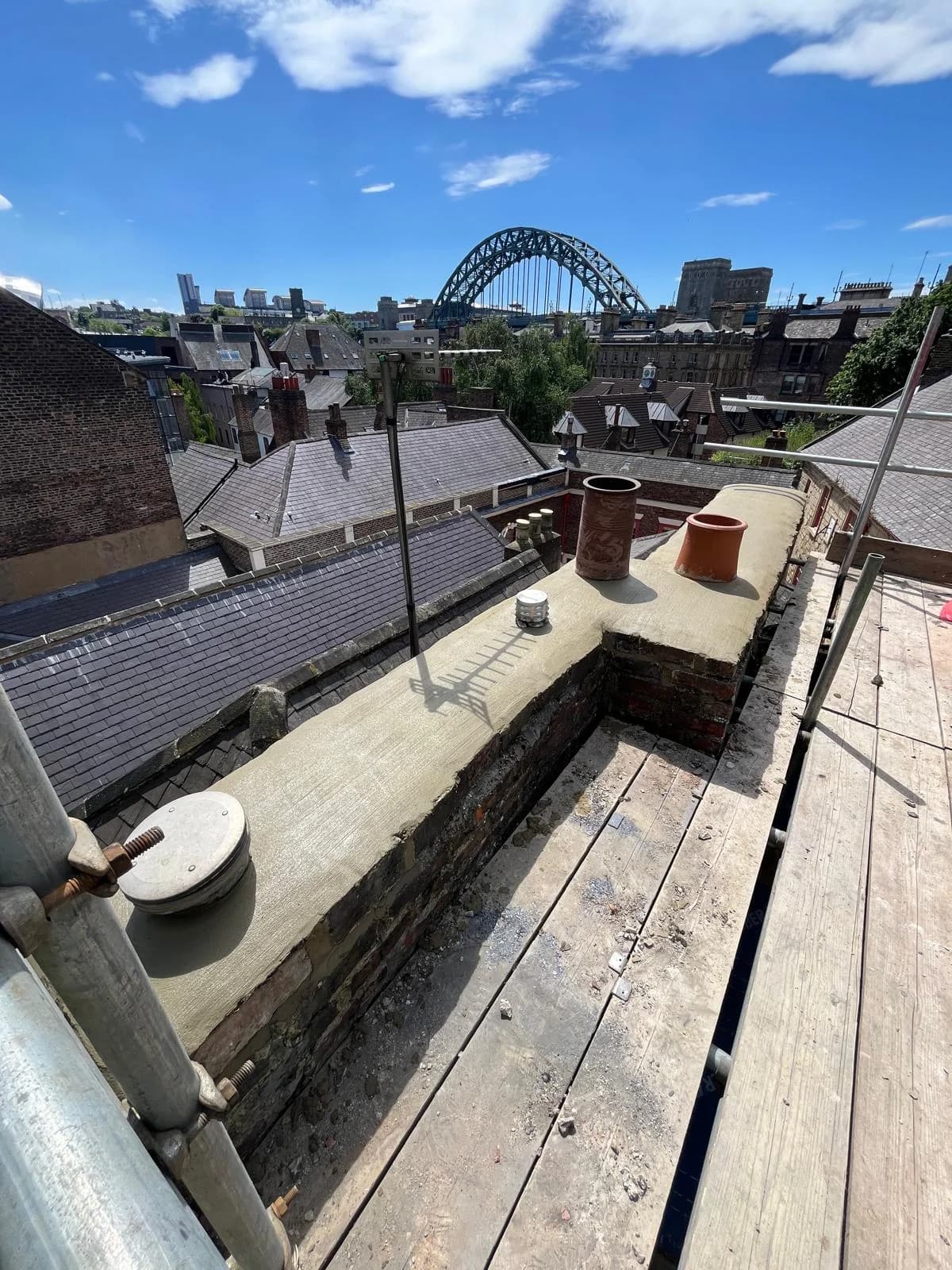 Lead-clad roof detail with the Tyne Bridge visible in the background — Newcastle heritage leadwork